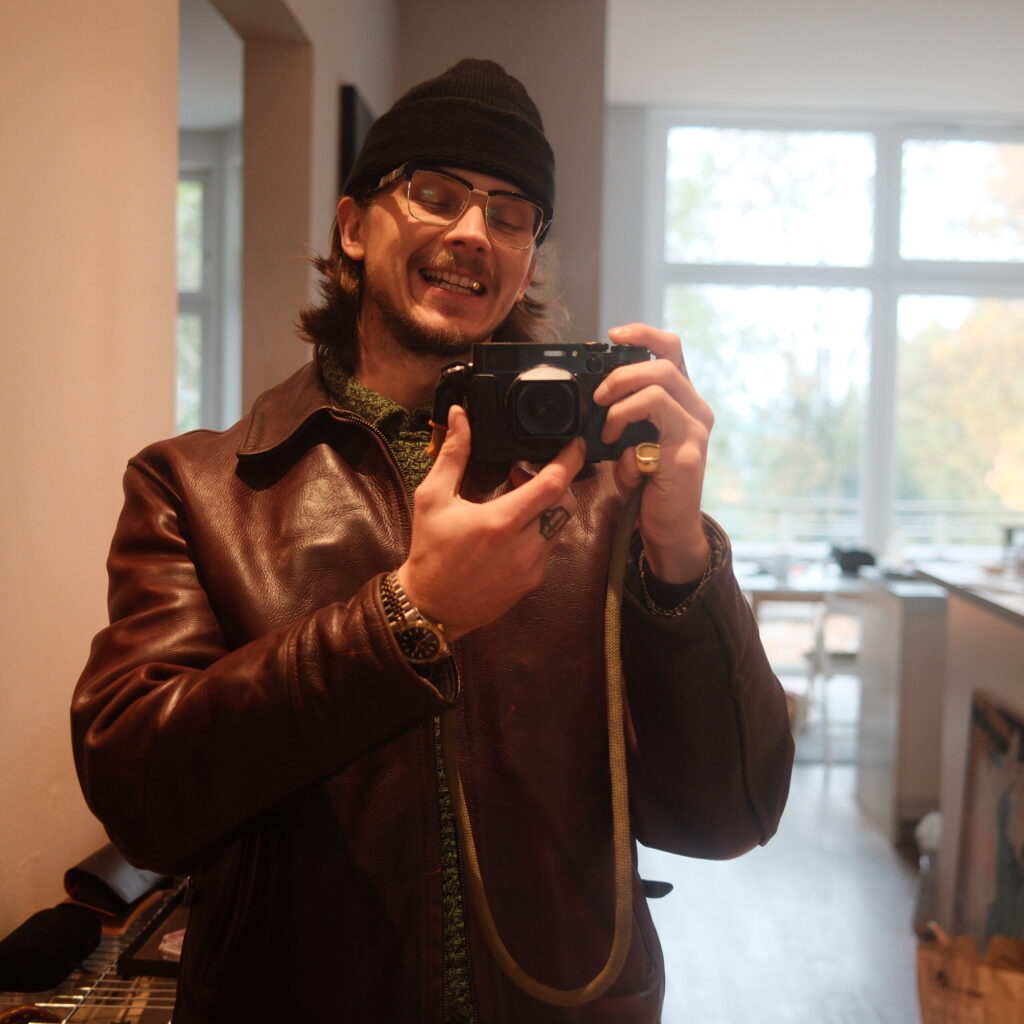 Pete from Stable & Petegottaste with Aero Leather Jacket, Fujifilm x100vi, Merz b. Schwanen Beanie, Gucci Glasses